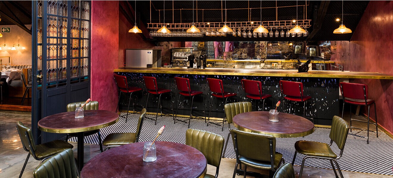 The interiors of The Shortmarket Club keep with the opulent, old-world feel of the building and recall the history of the space. The interiors of The Shortmarket Club keep with the opulent, old-world feel of the building and recall the history of the space.